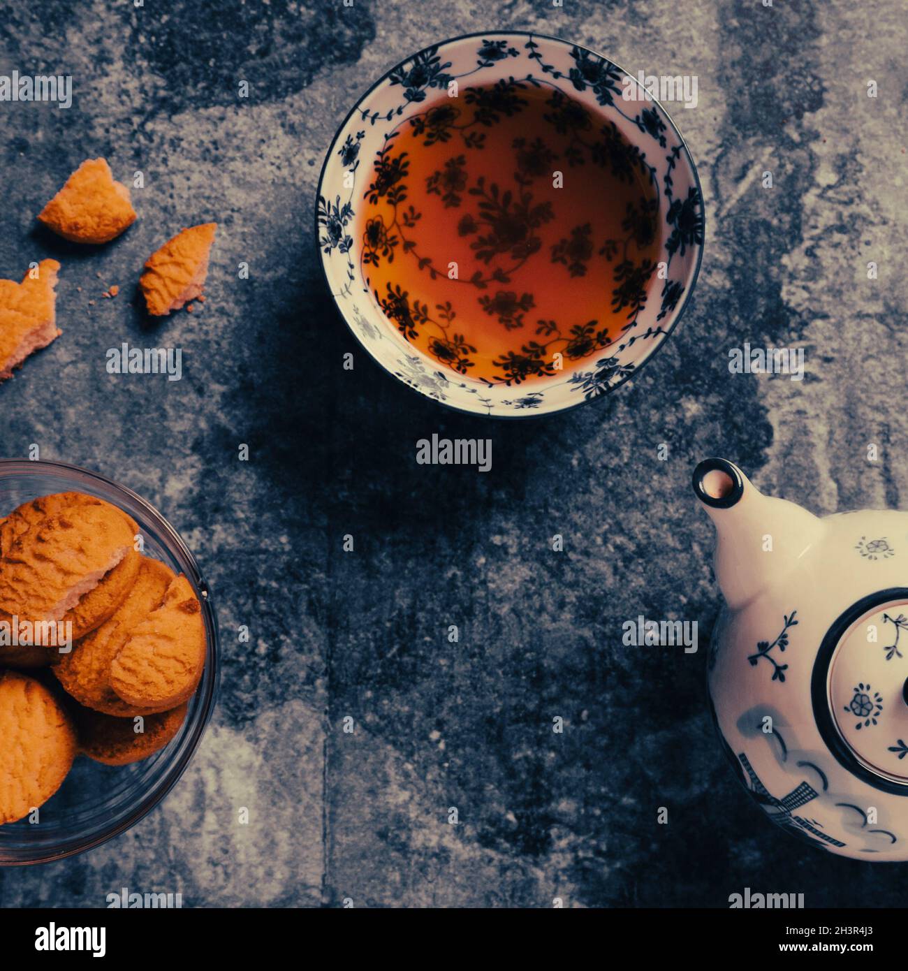 Calm China tea set with yummy biscuits on the blue table. Relaxing time, top view, overhead shooting. Stock Photo