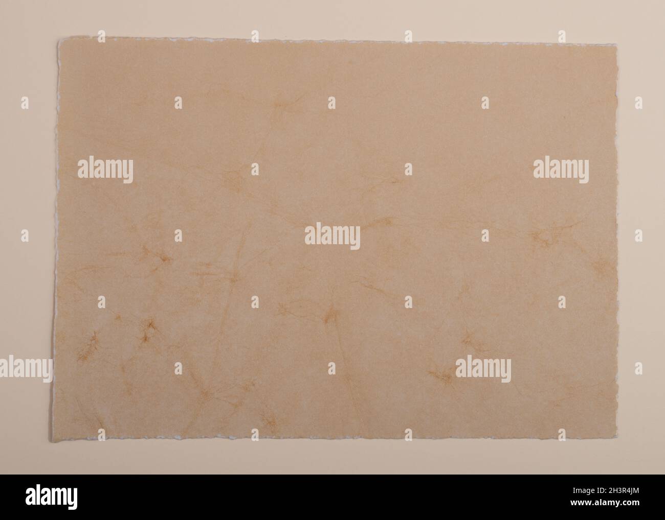 Old vintage paper background. Textured grunge surface. Stock Photo