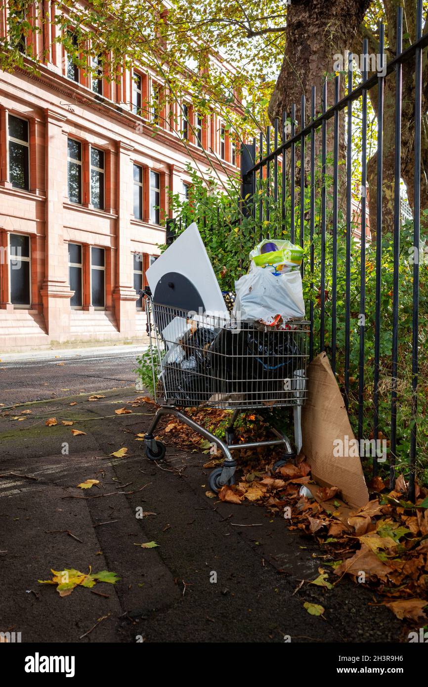 Abandoned shopping trolley filled with rubbish Stock Photo