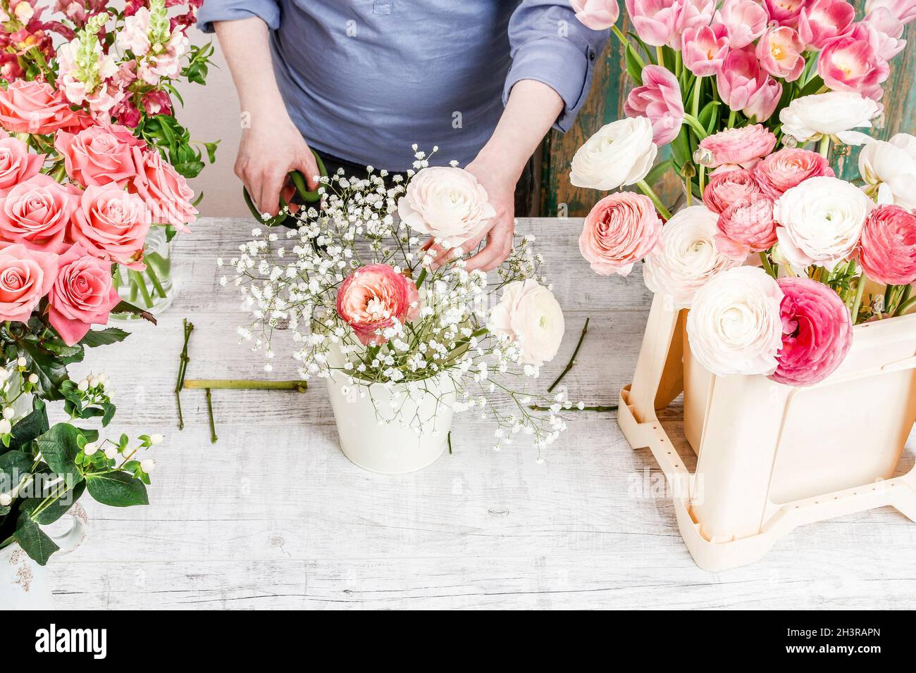 Work Sorting Roses Florist workplace: woman arranging a bouquet with roses, matthiolas ...