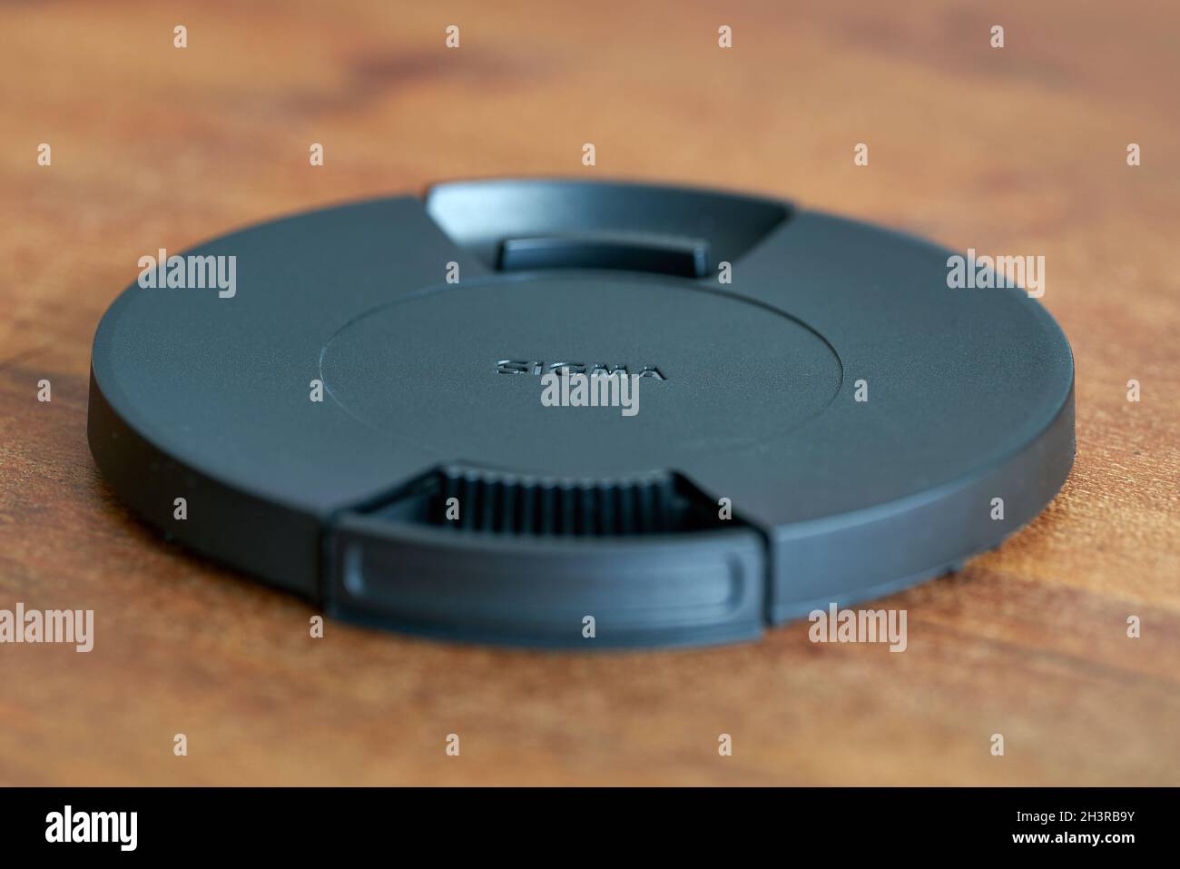 Lens cap for lenses of Japanese manufacturer Sigma on a table Stock Photo