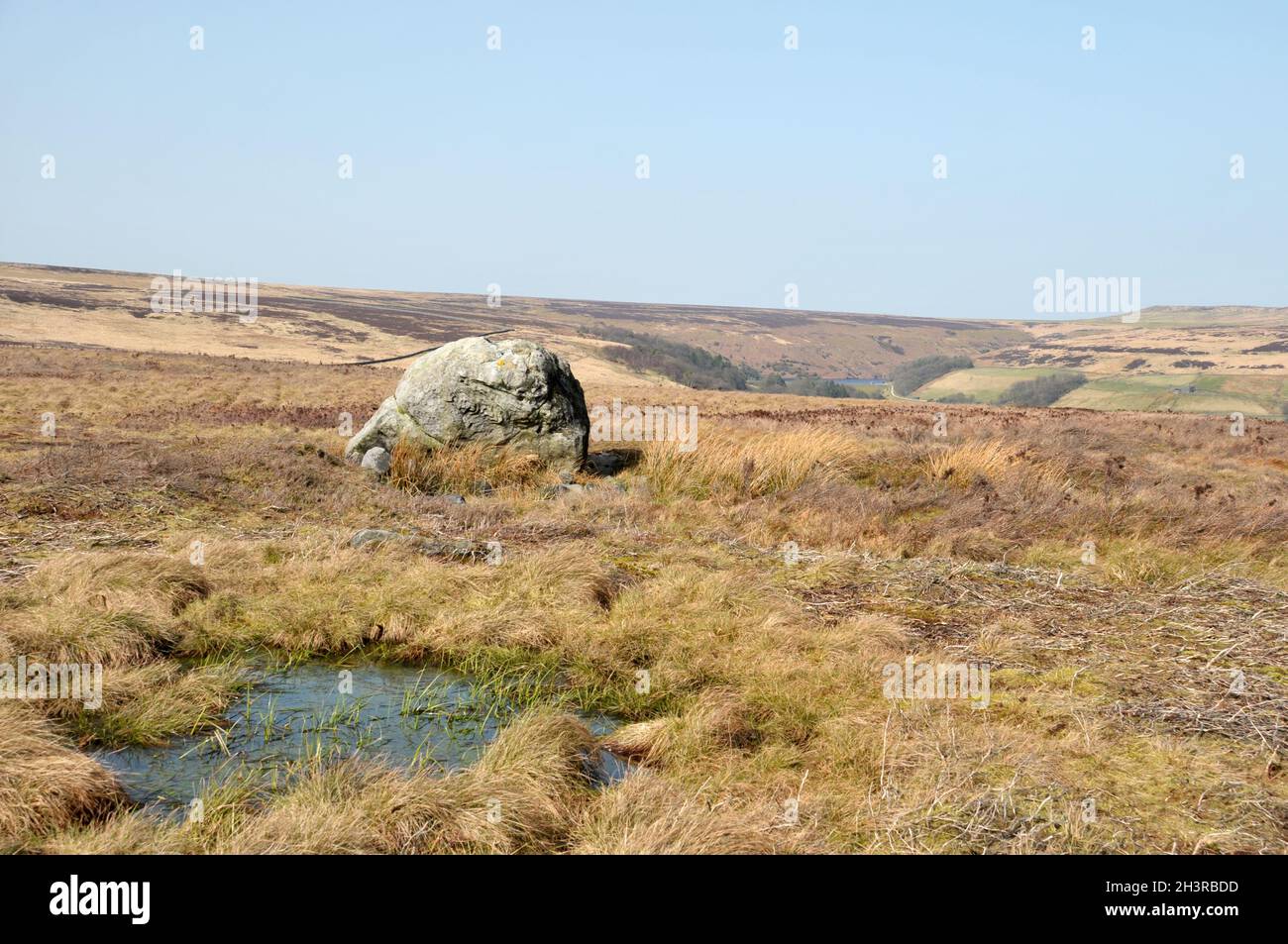 Pennine landscape with large old boulder or standing stone on midgley moor in west yorkshire Stock Photo