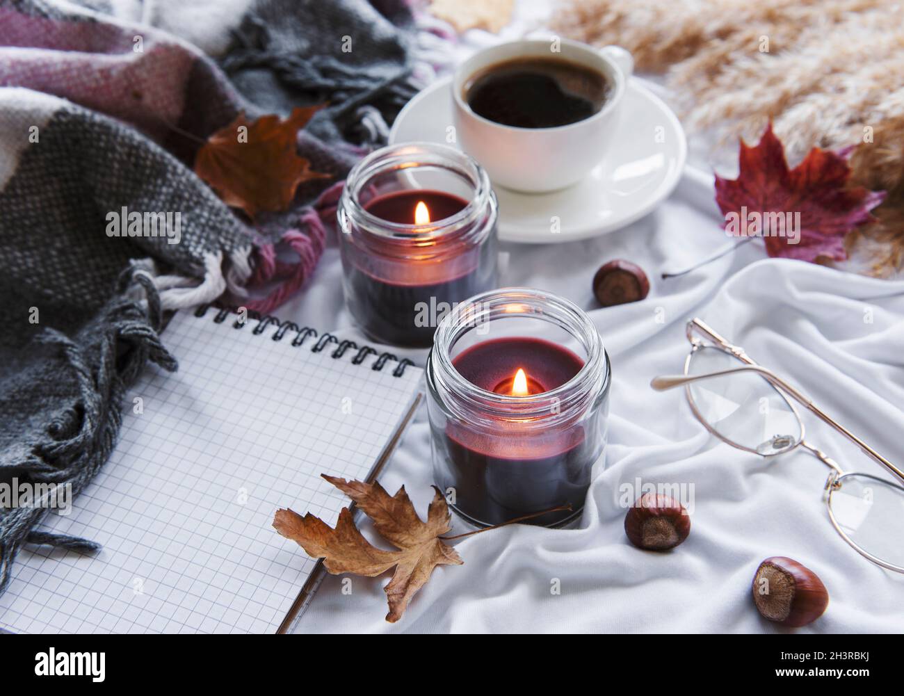 Autumn still life with pumpkins, coffee and burning candles. Cozy fall ...
