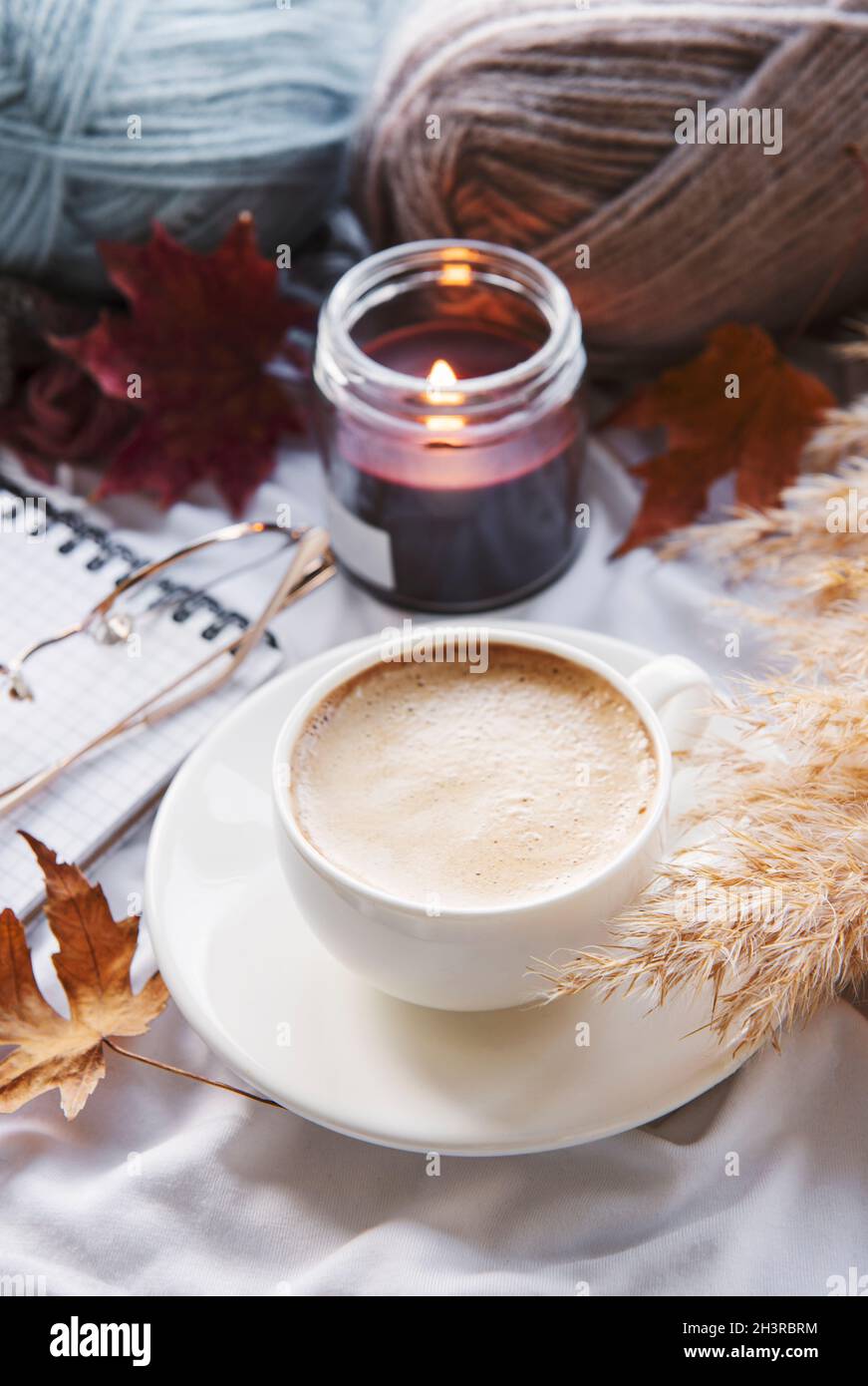 Autumn still life with pumpkins, coffee and burning candles. Cozy fall ...