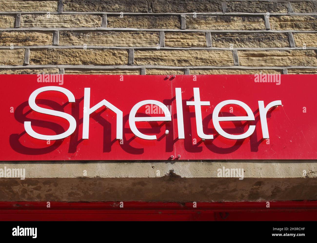 Sign above a shelter charity shop in hebden bridge Stock Photo Alamy