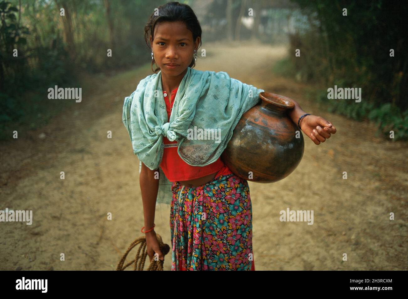Nepal, Terai area, Tharu woman bring water. Stock Photo
