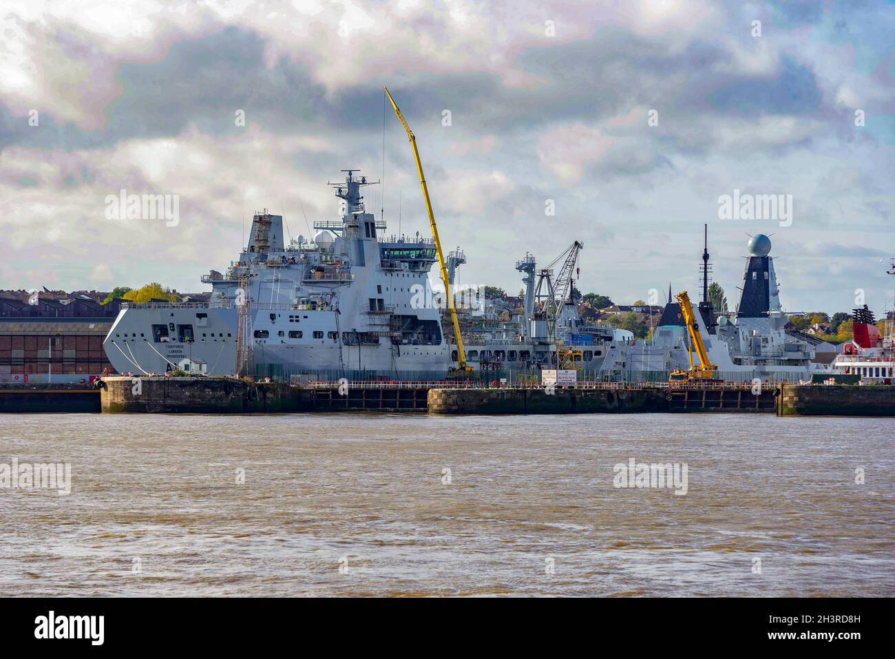 Royal Navy ships indock at Camell Lairds shipyard in Birkenhead on the Wirral. RFA Tideforce on the left. Stock Photo
