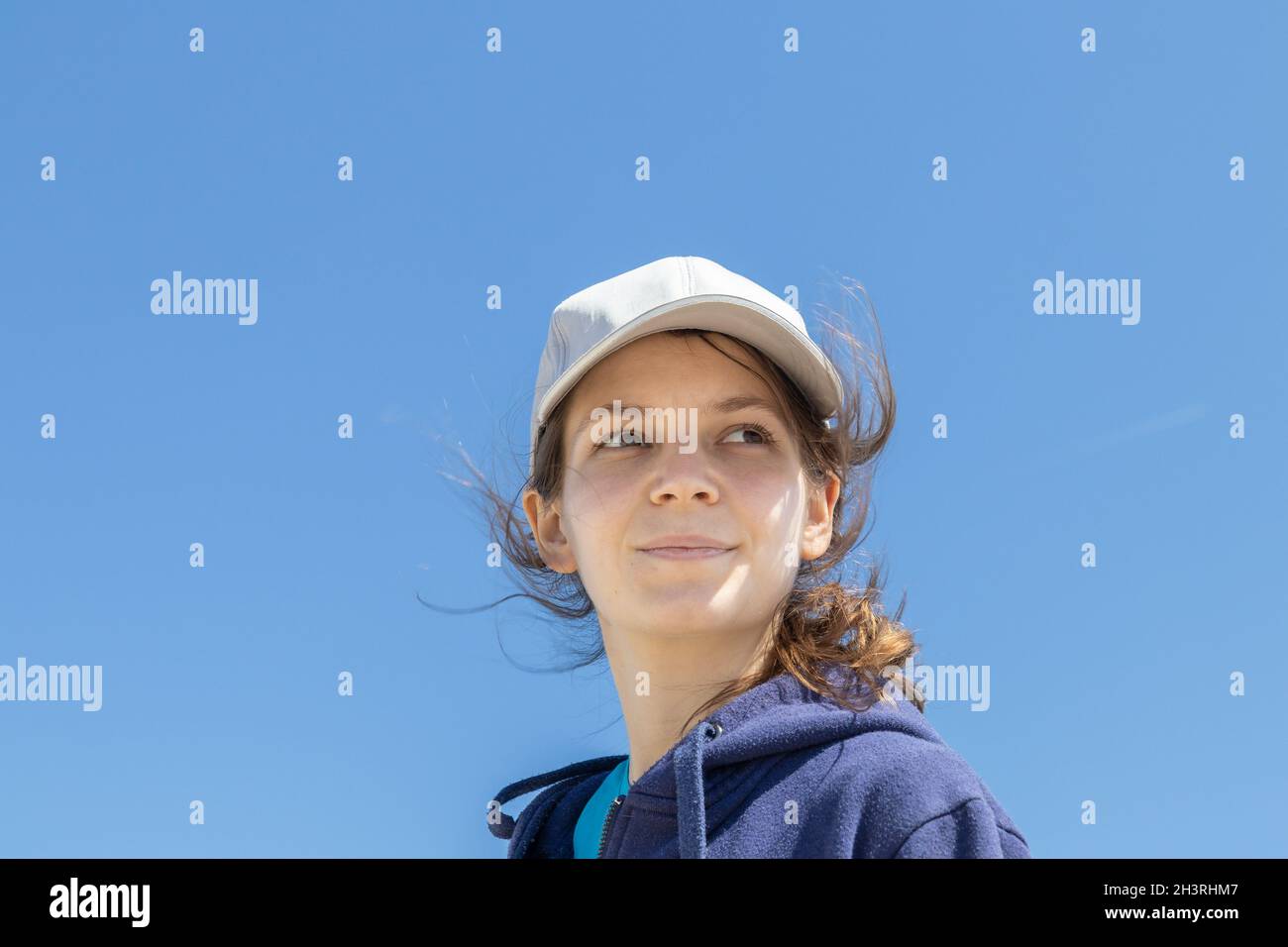 Natural face portrait of a young caucasian woman, no retouching skin, no color correction. Close-up girl outdoor portrait on a sky background, brunett Stock Photo