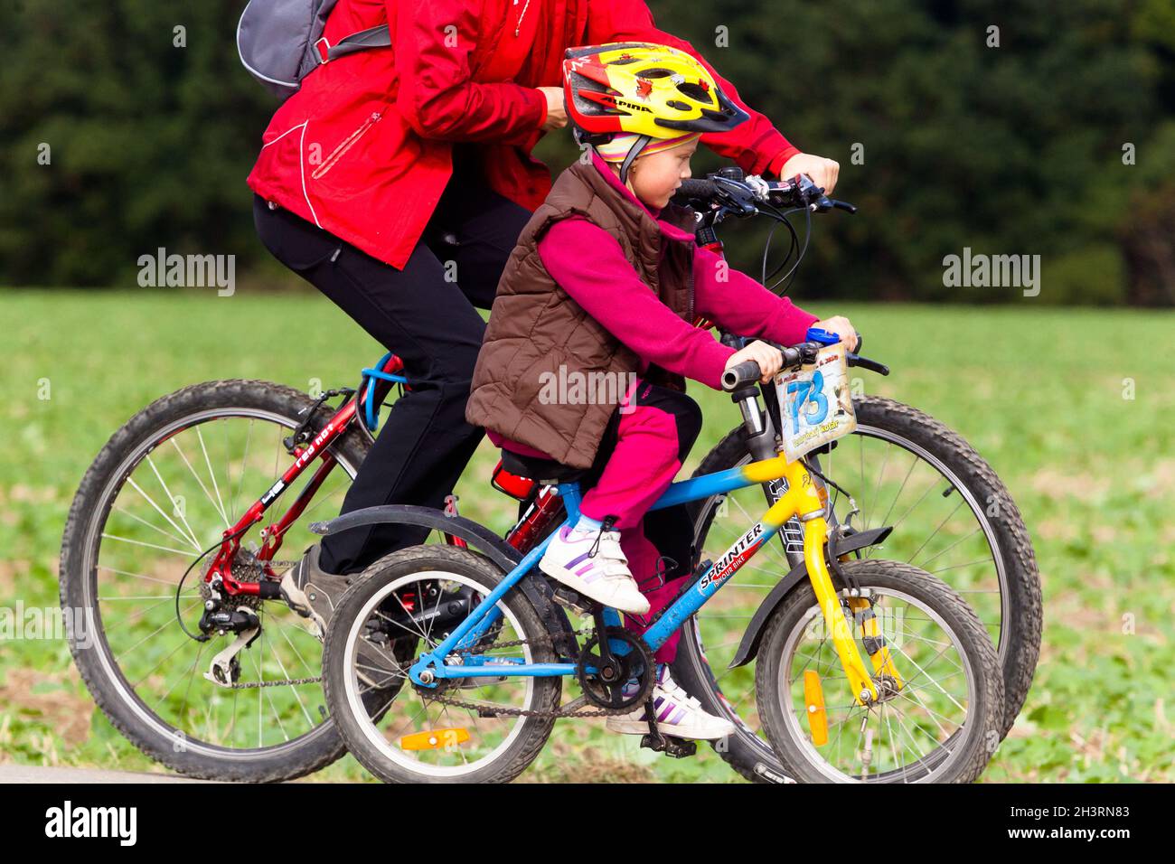 Child riding bicycle with helmet, boy ride a bike, childs helmet Stock