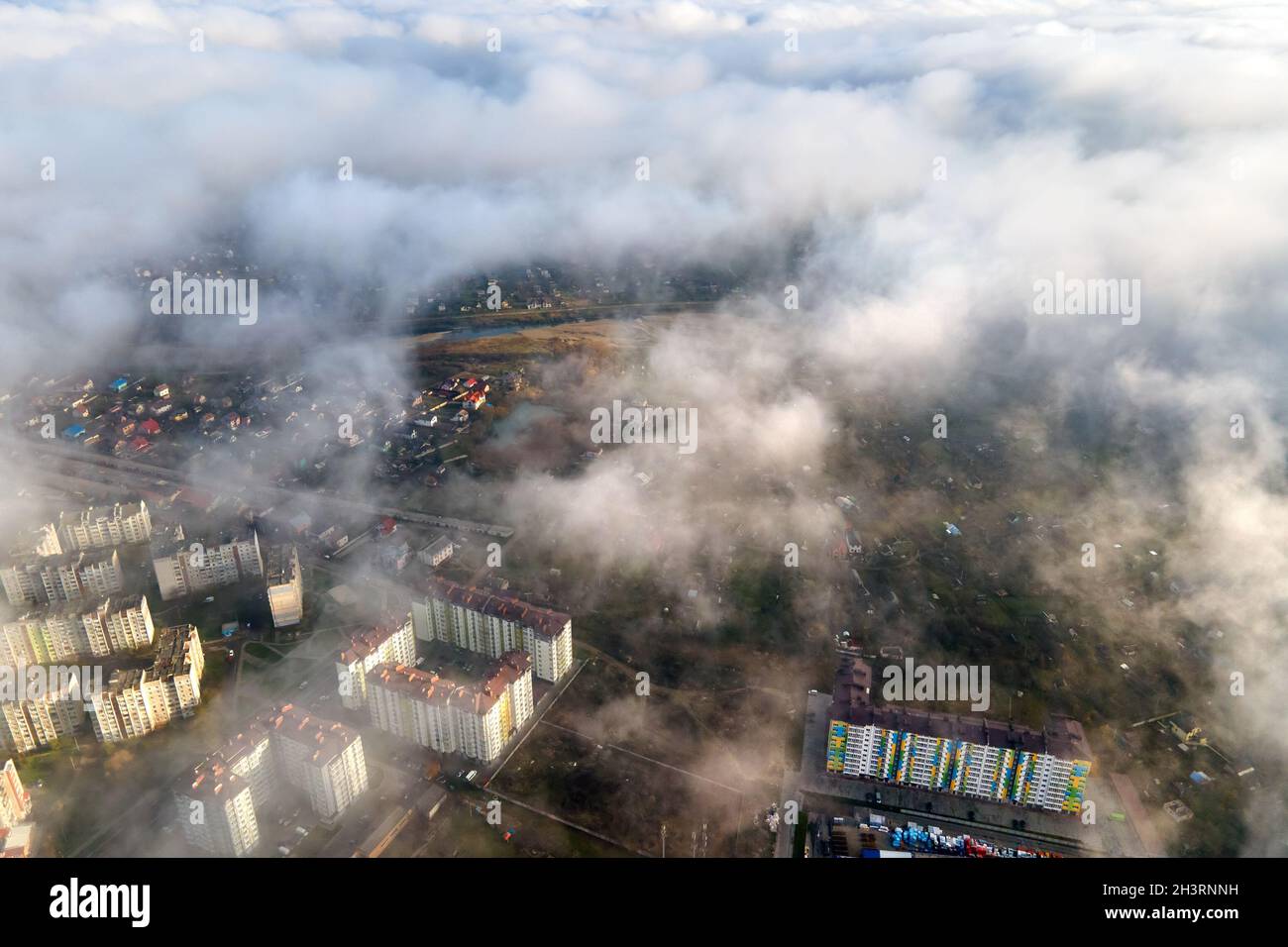 Top aerial view of fluffy white clouds over modern city with high rise ...