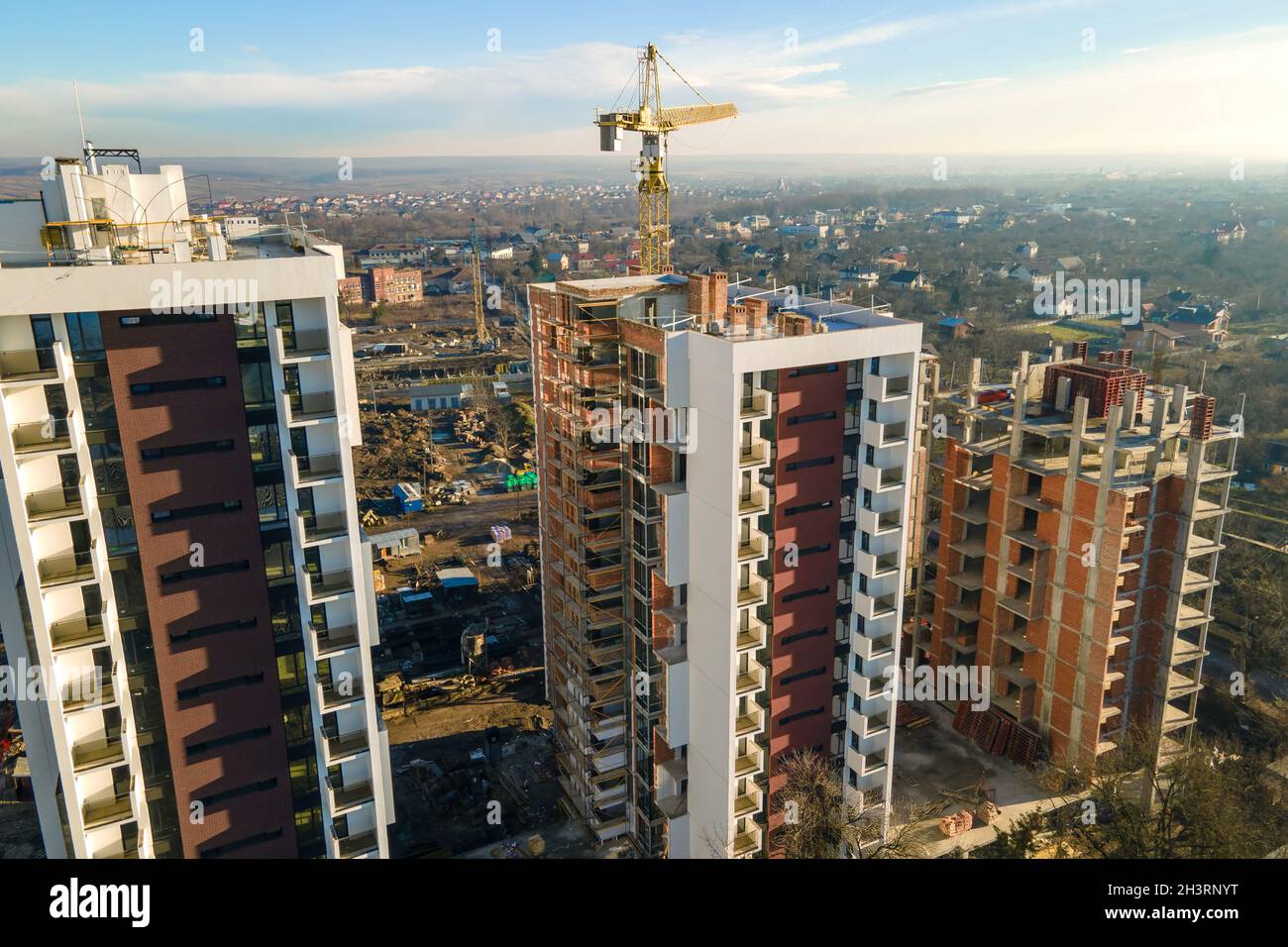Aerial view of high tower crane and residential apartment buildings ...