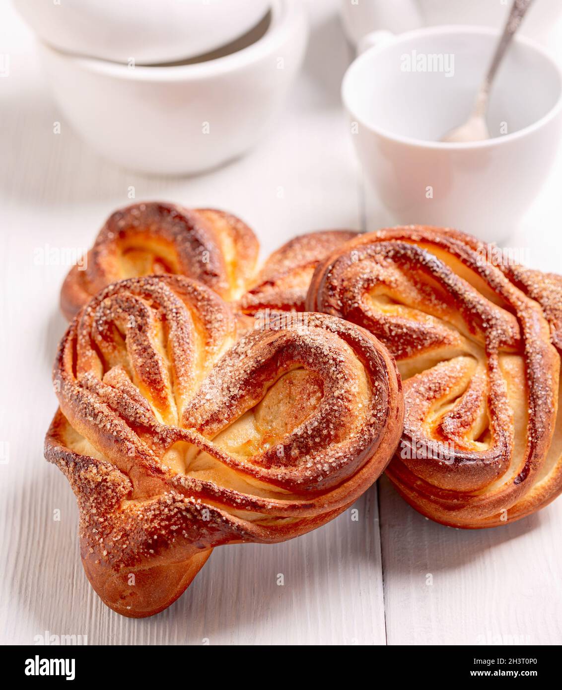 Sweet swirling buns sprinkled with sugar. Stock Photo