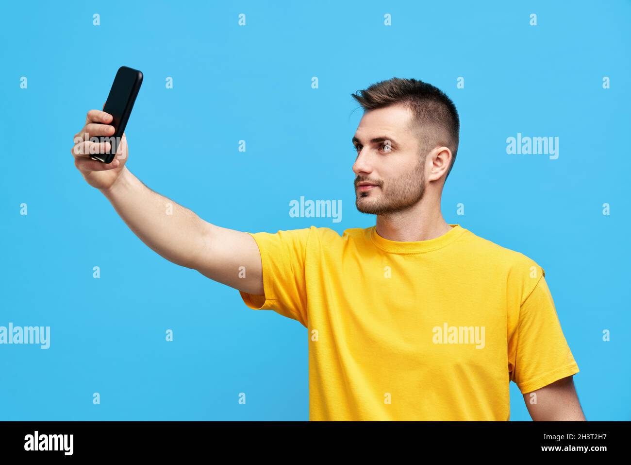 Handsome young man taking selfie over blue backgroundfvg Stock Photo