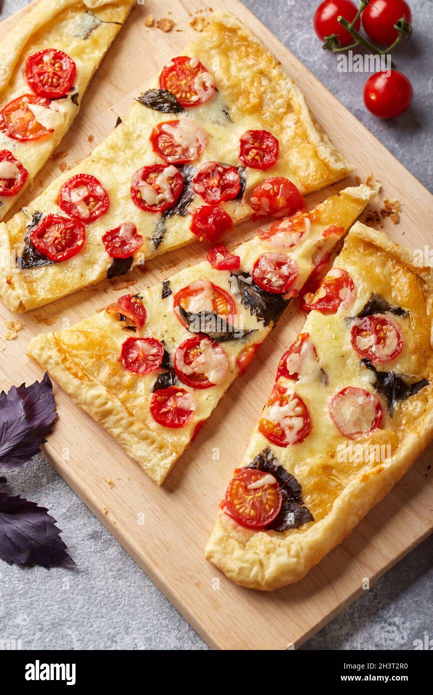 Puff pastry tart with cherry tomatoes, mozzarella and purple basil