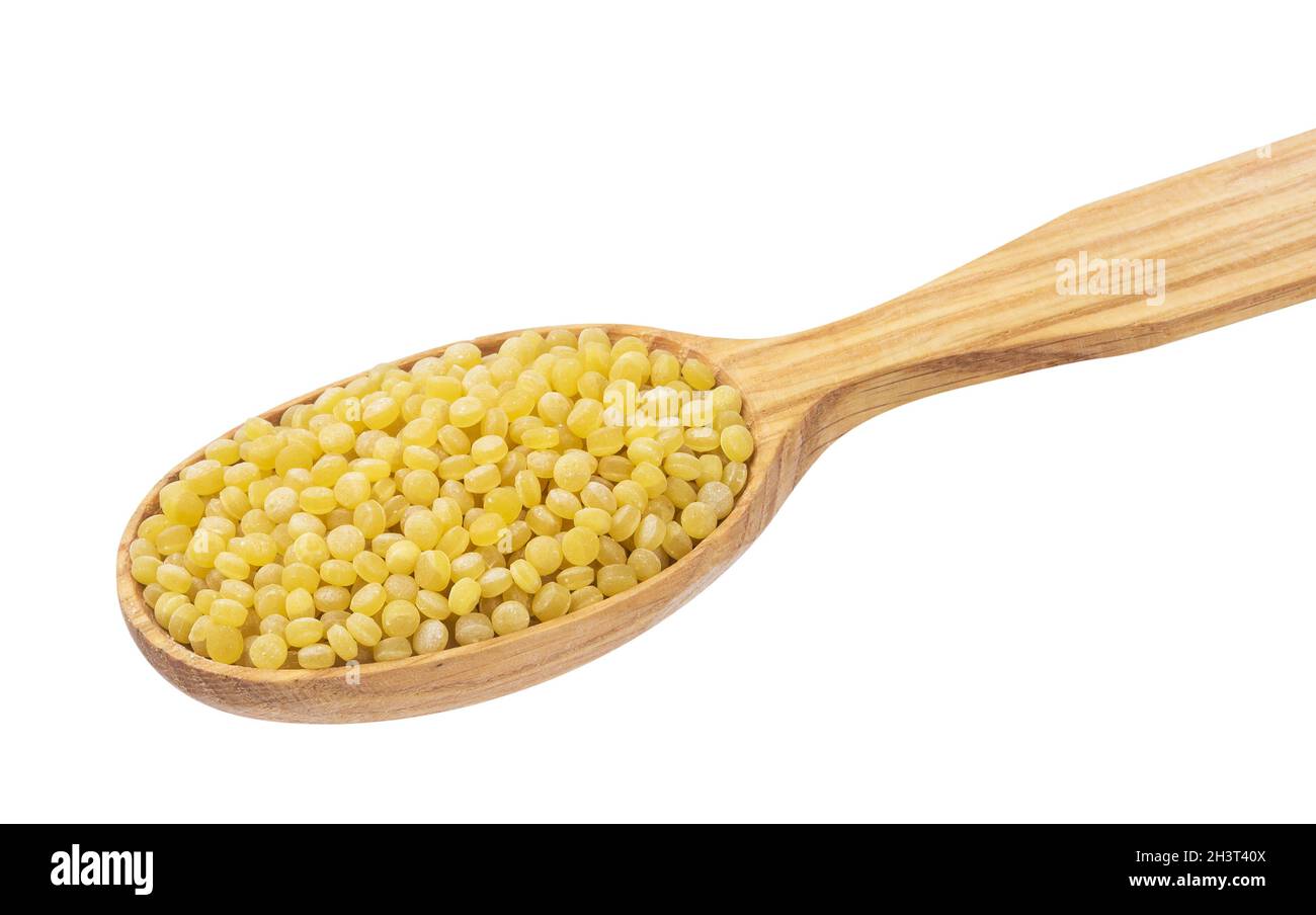 Israeli couscous. Ptitim in wooden spoon isolated on white background Stock Photo
