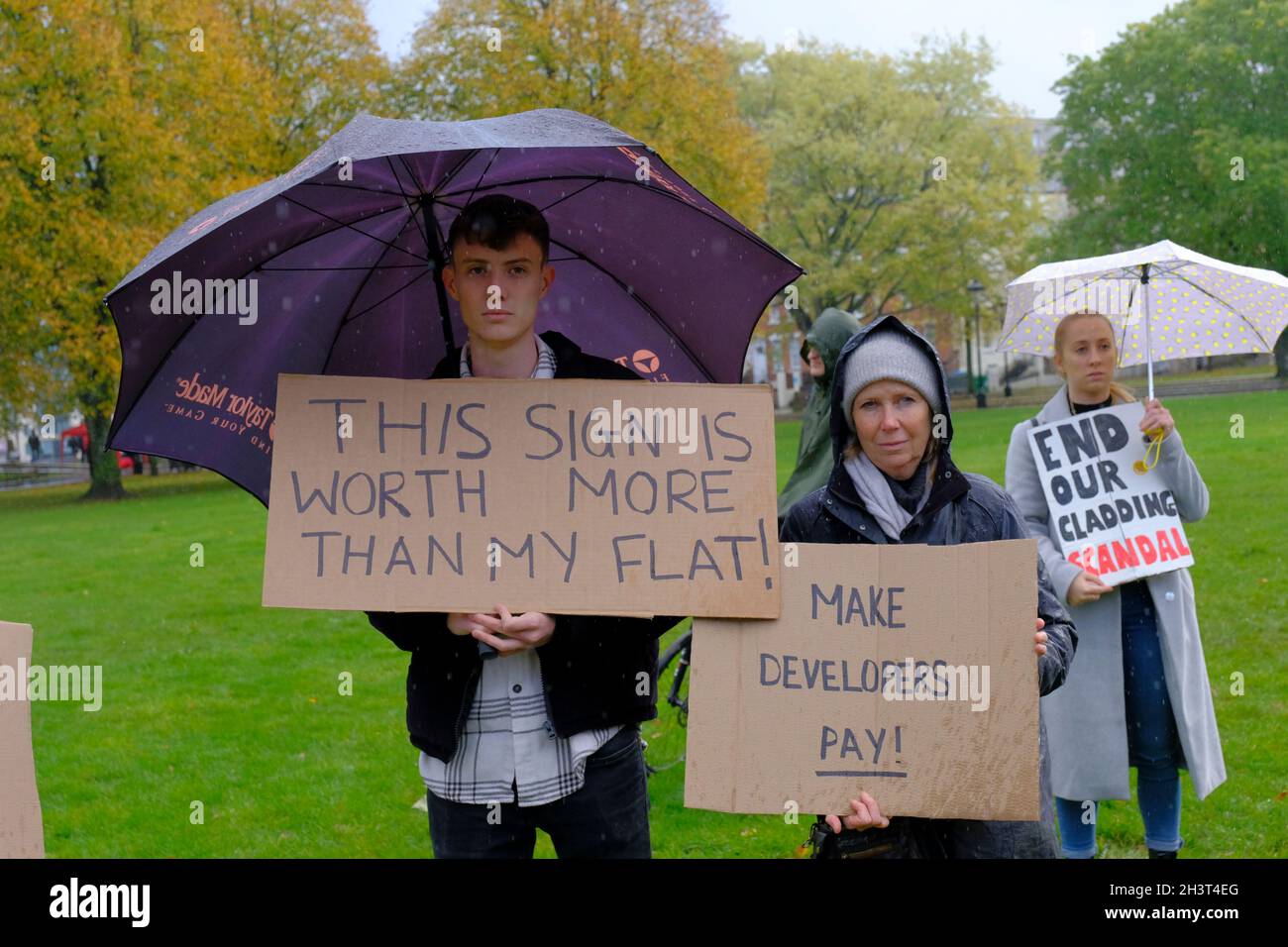 Bristol, UK. 30th Oct, 2021. Protesting in the rain. Leaseholders affected by the cost of making their homes safe hold a rally on College Green, Bristol. The aftermath of the Grenfell fire is the need to remove flammable cladding from homes, but the cost is being placed upon the leaseholders and not the builders and developers who fitted the dangerous cladding. Credit: JMF News/Alamy Live News Stock Photo