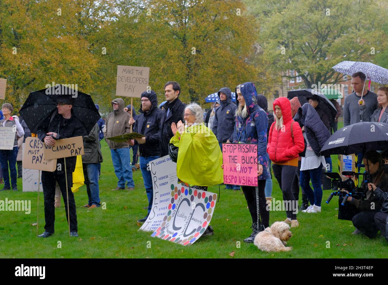 Bristol, UK. 30th Oct, 2021. Protesting in the rain. Leaseholders affected by the cost of making their homes safe hold a rally on College Green, Bristol. The aftermath of the Grenfell fire is the need to remove flammable cladding from homes, but the cost is being placed upon the leaseholders and not the builders and developers who fitted the dangerous cladding. Credit: JMF News/Alamy Live News Stock Photo
