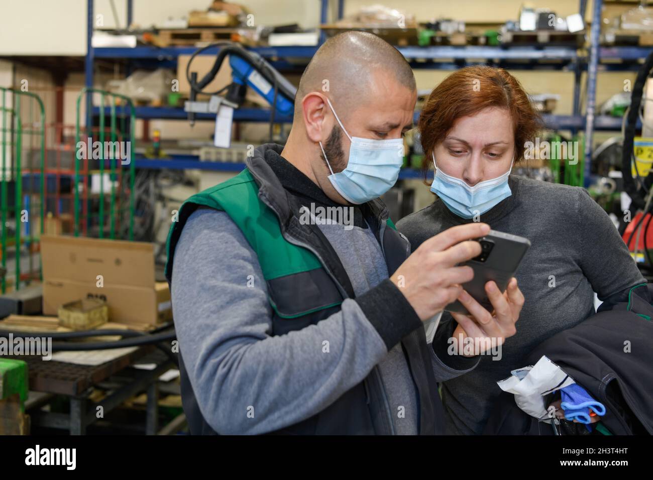 Industrial workers with face masks protected against corona virus ...