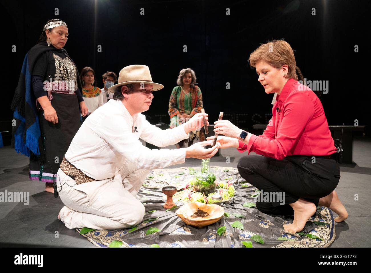 First Minister Nicola Sturgeon welcomes Mapuche leader and Minga Indigena Lead Coordinator Claflin Lafkenche (left) alongside indigenous delegates at a ceremonial gathering at the Tramway in Glasgow in a symbolic gesture to mark a unified demand for climate justice. Picture date: Saturday October 30, 2021. Stock Photo