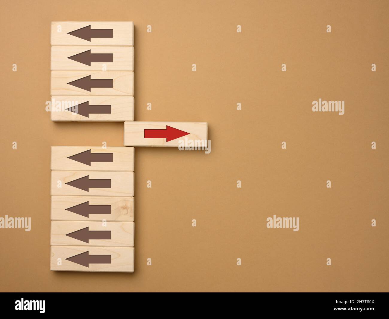 Wooden blocks with brown arrows in one direction and one block with a ...