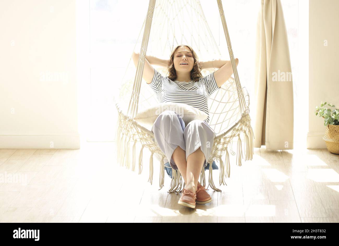 Hanging chair and woman hi-res stock photography and images - Alamy