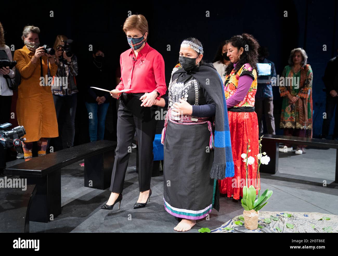 First Minister Nicola Sturgeon with Mapuche elder Panchita Calfin (right) during a special ceremonial gathering to welcome the Mapuche leader and Minga Indigena indigenous delegates at the Tramway in Glasgow in a symbolic gesture to mark a unified demand for climate justice. Picture date: Saturday October 30, 2021. Stock Photo