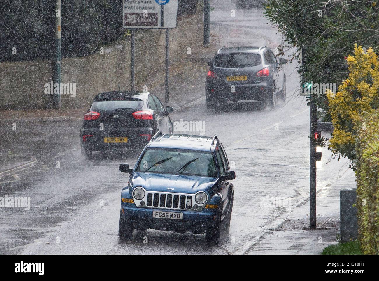Chippenham, Wiltshire, UK. 30th October, 2021. Drivers are pictured braving heavy rain in Chippenham as heavy rain showers make their way across the UK. Credit: Lynchpics/Alamy Live News Stock Photo