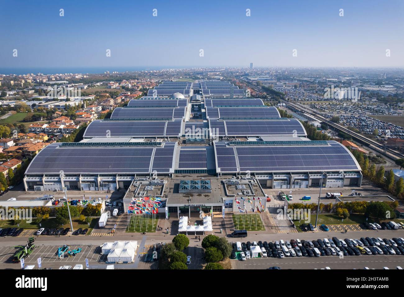 Aerial view of the roofs of the Rimini Fiera pavilions entirely covered with solar panels. Rimini, Italy - October 2021 Stock Photo
