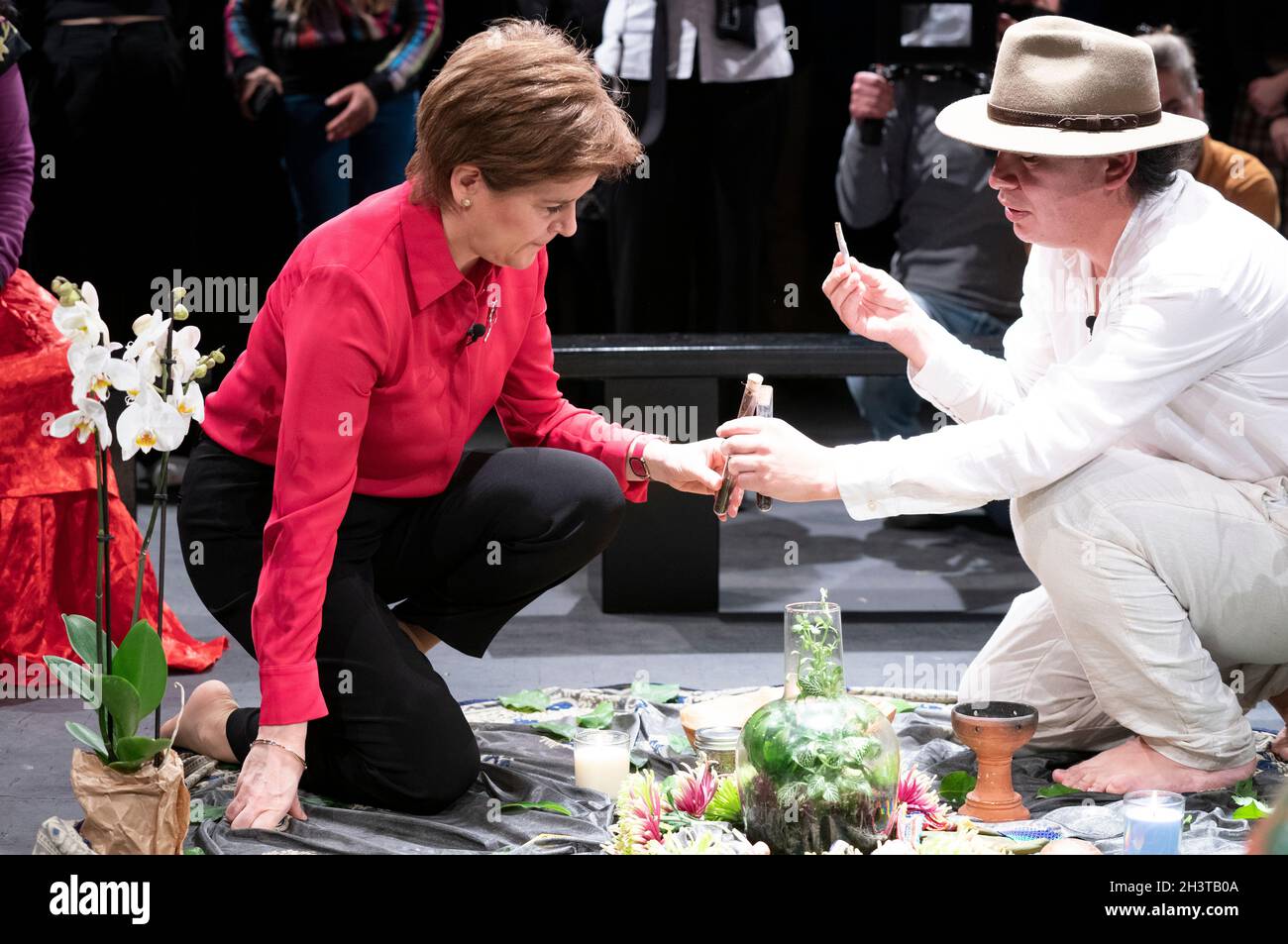 First Minister Nicola Sturgeon welcomes Mapuche leader and Minga Indigena Lead Coordinator Claflin Lafkenche (right) alongside indigenous delegates at a ceremonial gathering at the Tramway in Glasgow in a symbolic gesture to mark a unified demand for climate justice. Picture date: Saturday October 30, 2021. Stock Photo