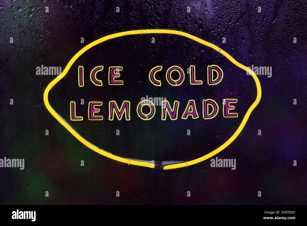 Ice Cold Lemonade Yellow Neon Sign in Rainy Window Stock Photo