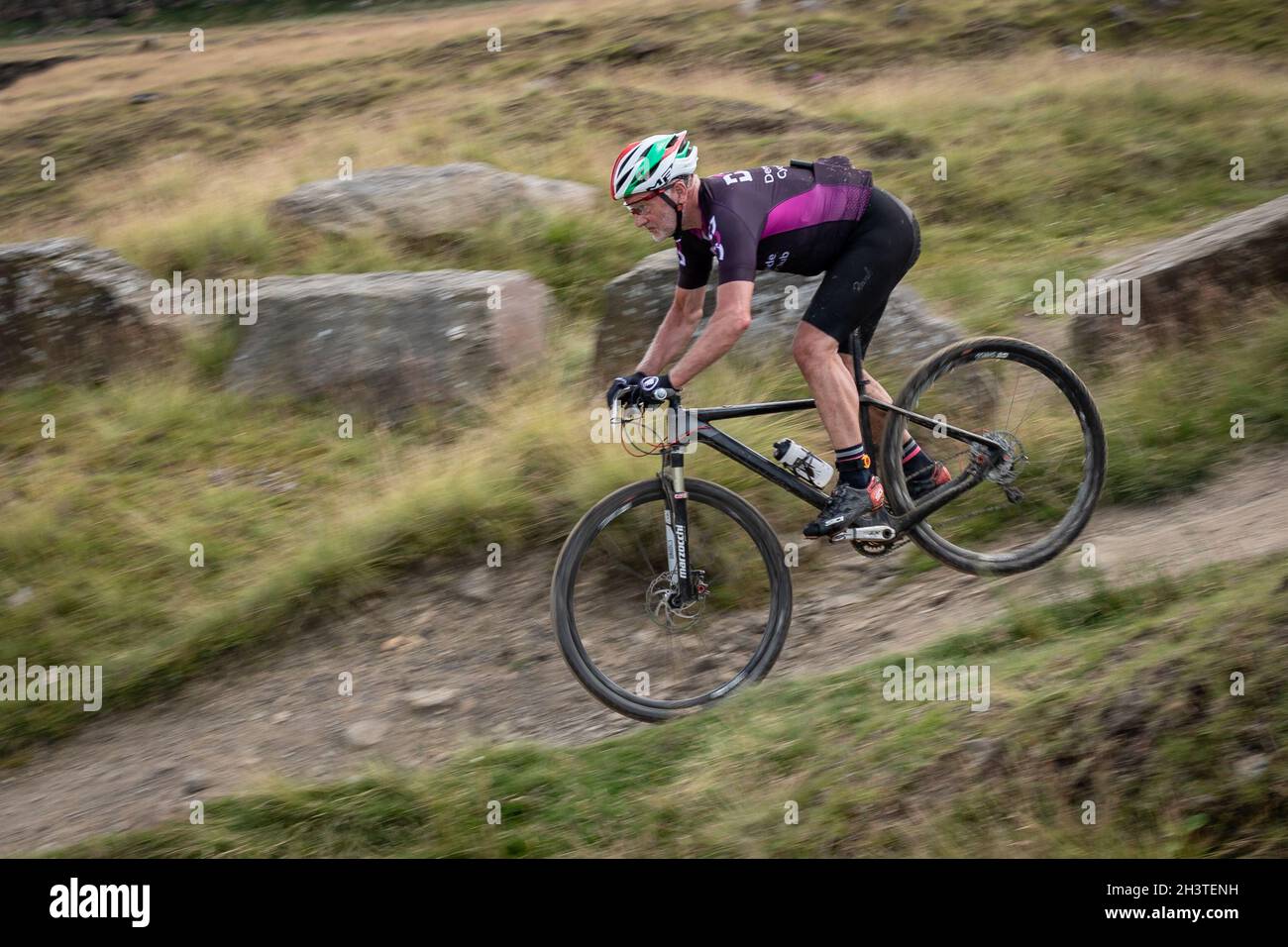 Mountain bike racer in 'Crank it' event, Lee Quarry, Lancashire, England, UK, GB, Europe. Stock Photo