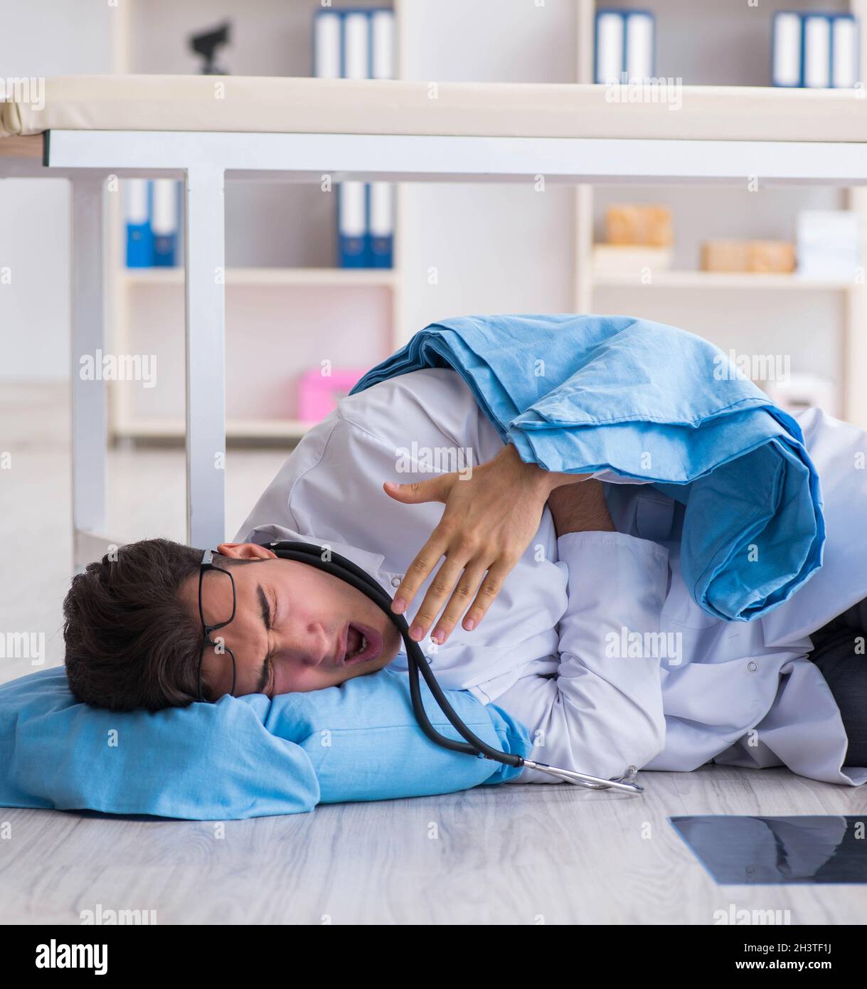 Doctor sleeping on floor after long night shift Stock Photo - Alamy