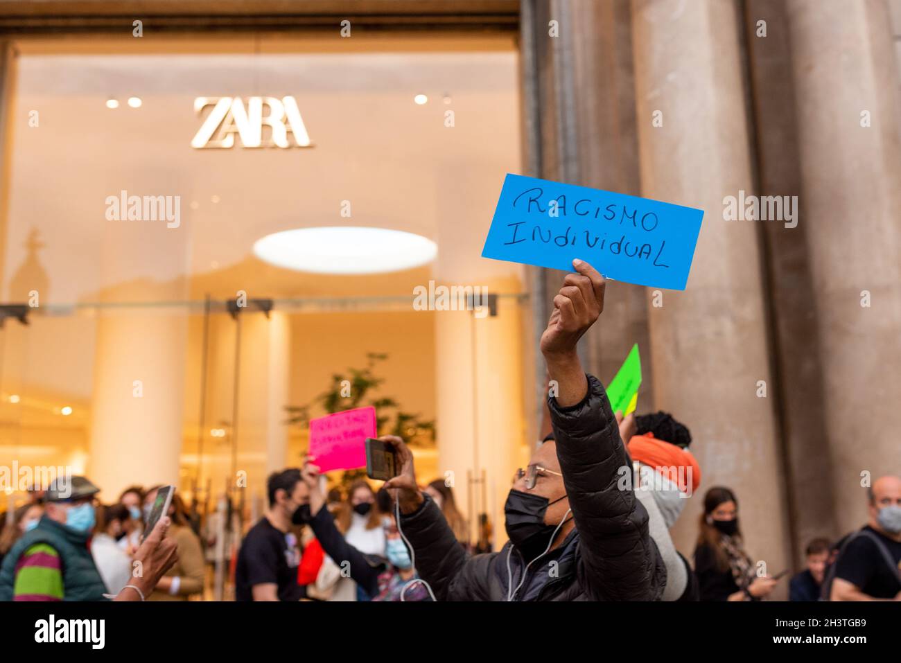 Spain. 29th Oct, 2021. A group of Brazilian activists holds a demonstration  inside and outside the main Spanish clothing store, Zara, to protest  against racist attacks that happened in the same stores