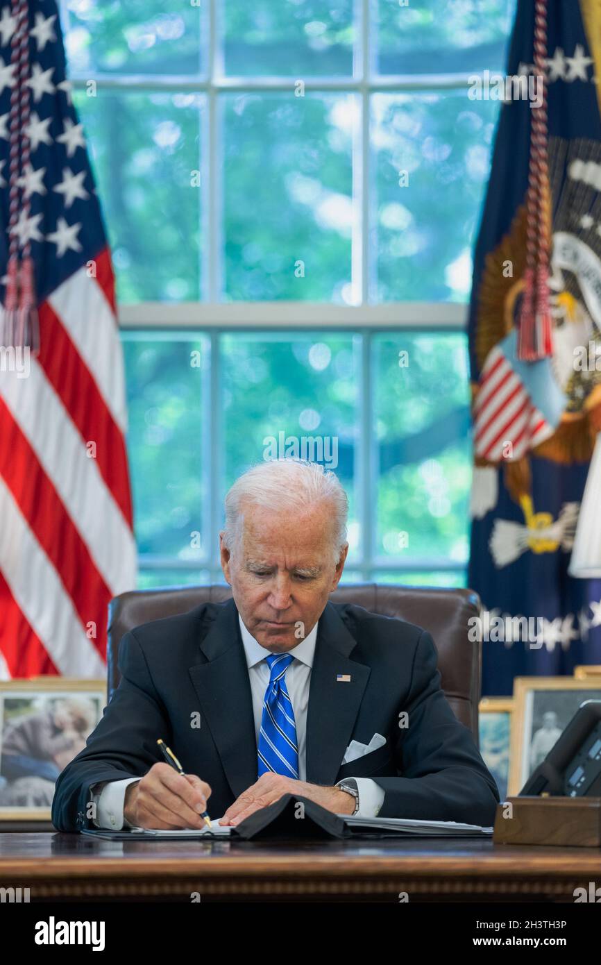 WASHINGTON DC, USA - 11 August 2021 - US President Joe Biden works in the Oval Office of the White House, Wednesday, August 11, 2021, prior to meeting Stock Photo