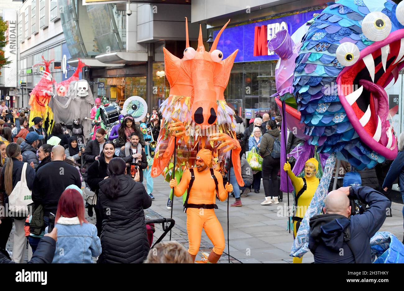 EDITORIAL USE ONLY Performers in monster costumes parade along Market ...