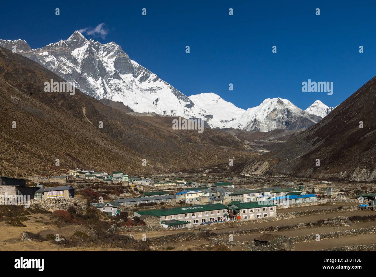 Lhotse, Shartse, Cho Polu and Imja Tse peaks  with Dingboche below them Stock Photo