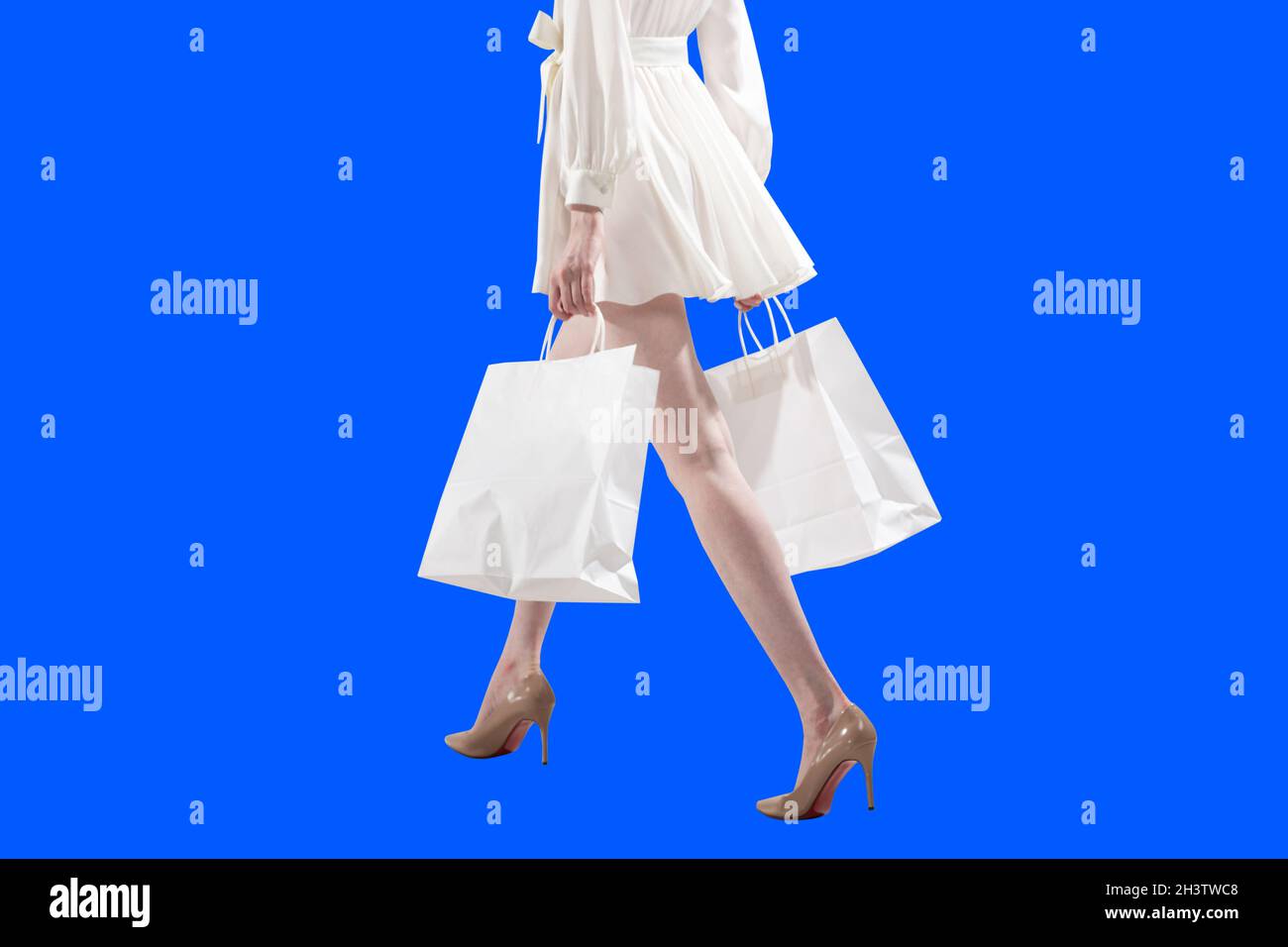 White caucasian albino blond woman holds black shopping bags. Sale and discounts on market and Black Friday concept. Stock Photo