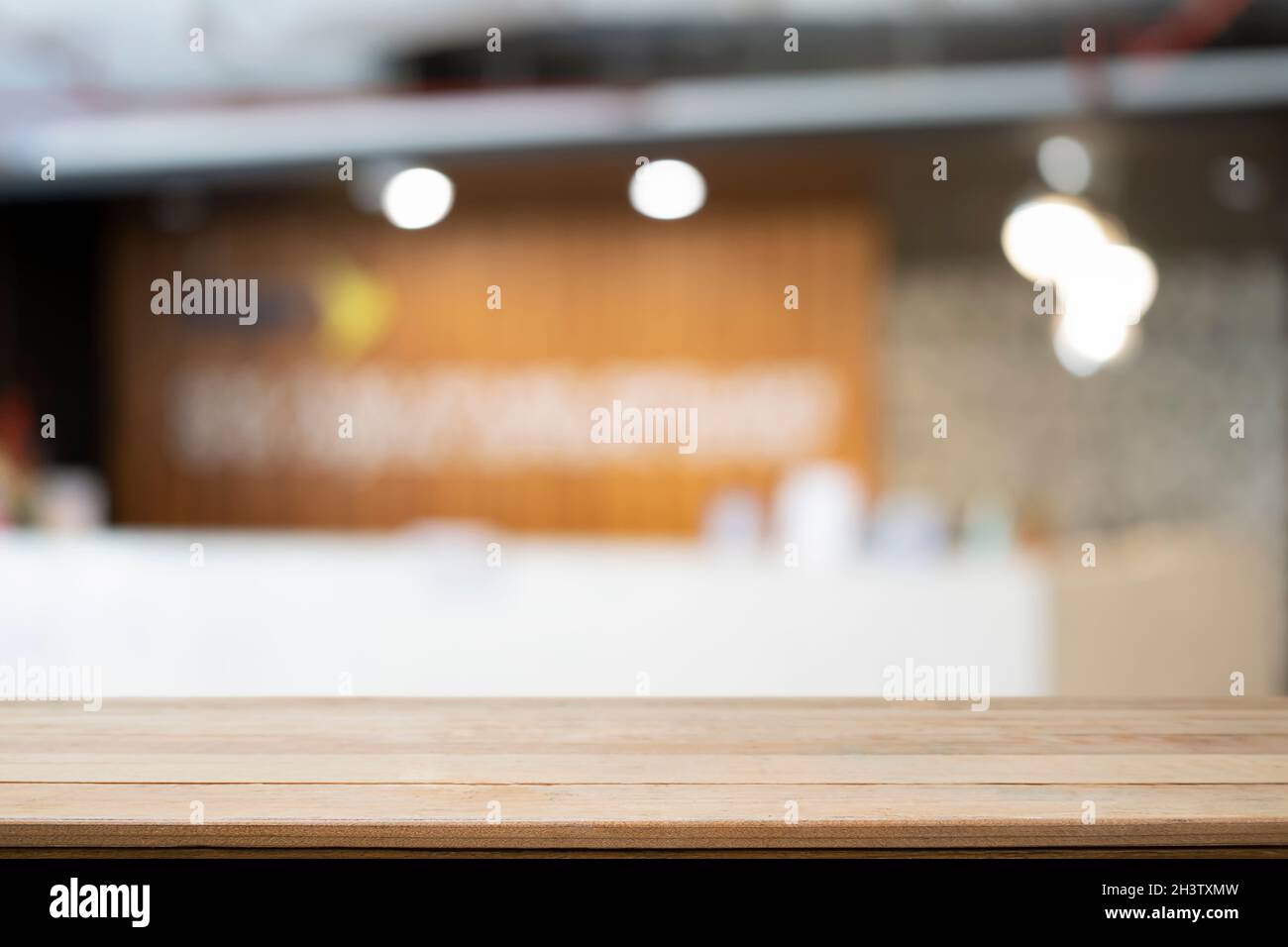 Wooden table with blurred coffee shop in background. For display or montage your products. Stock Photo