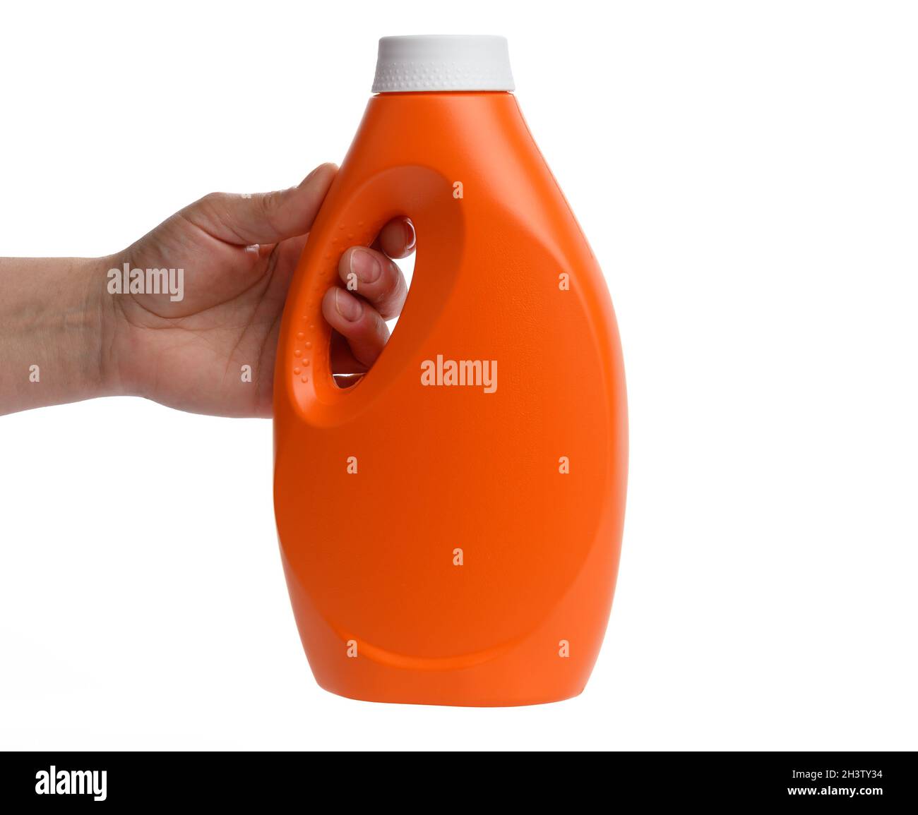 Female hand holding orange plastic bottle for liquid laundry detergent