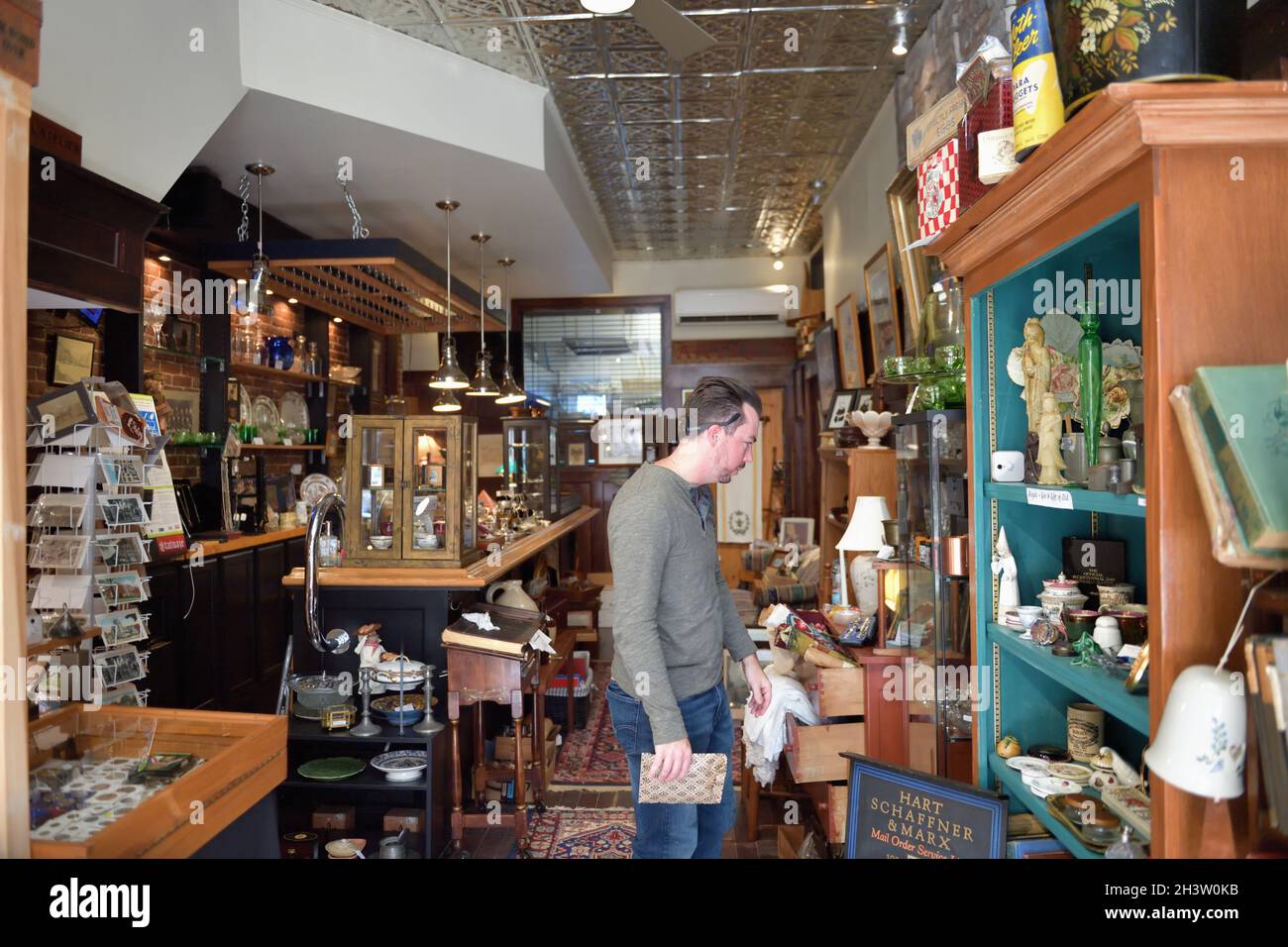 Gardiner, Maine, USA. Man browsing in one of the numerous shops along the pleasant and tidy main street in the small Maine community of Gardiner. Stock Photo
