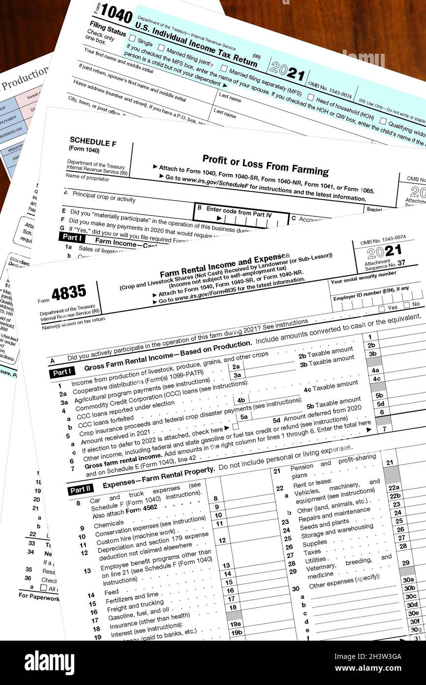 Blank 2021 IRS tax forms on a wooden desktop. Stock Photo