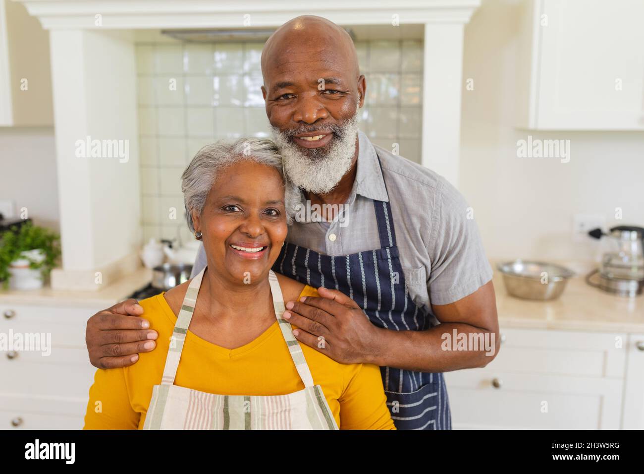 Portrait of senior african american couple in kitchen looking and ...