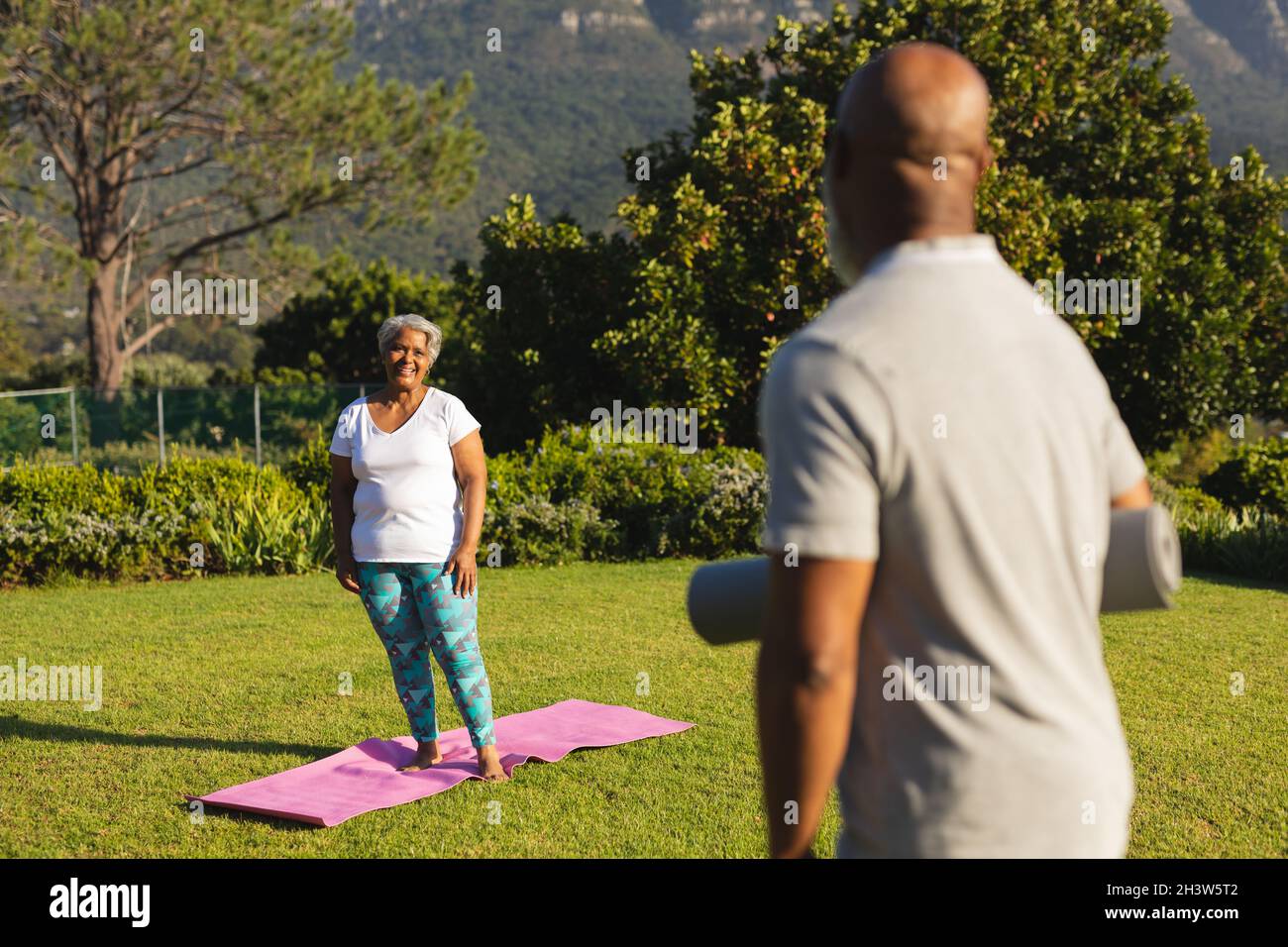 Portrait of smiling senior african american couple with yoga mat in ...