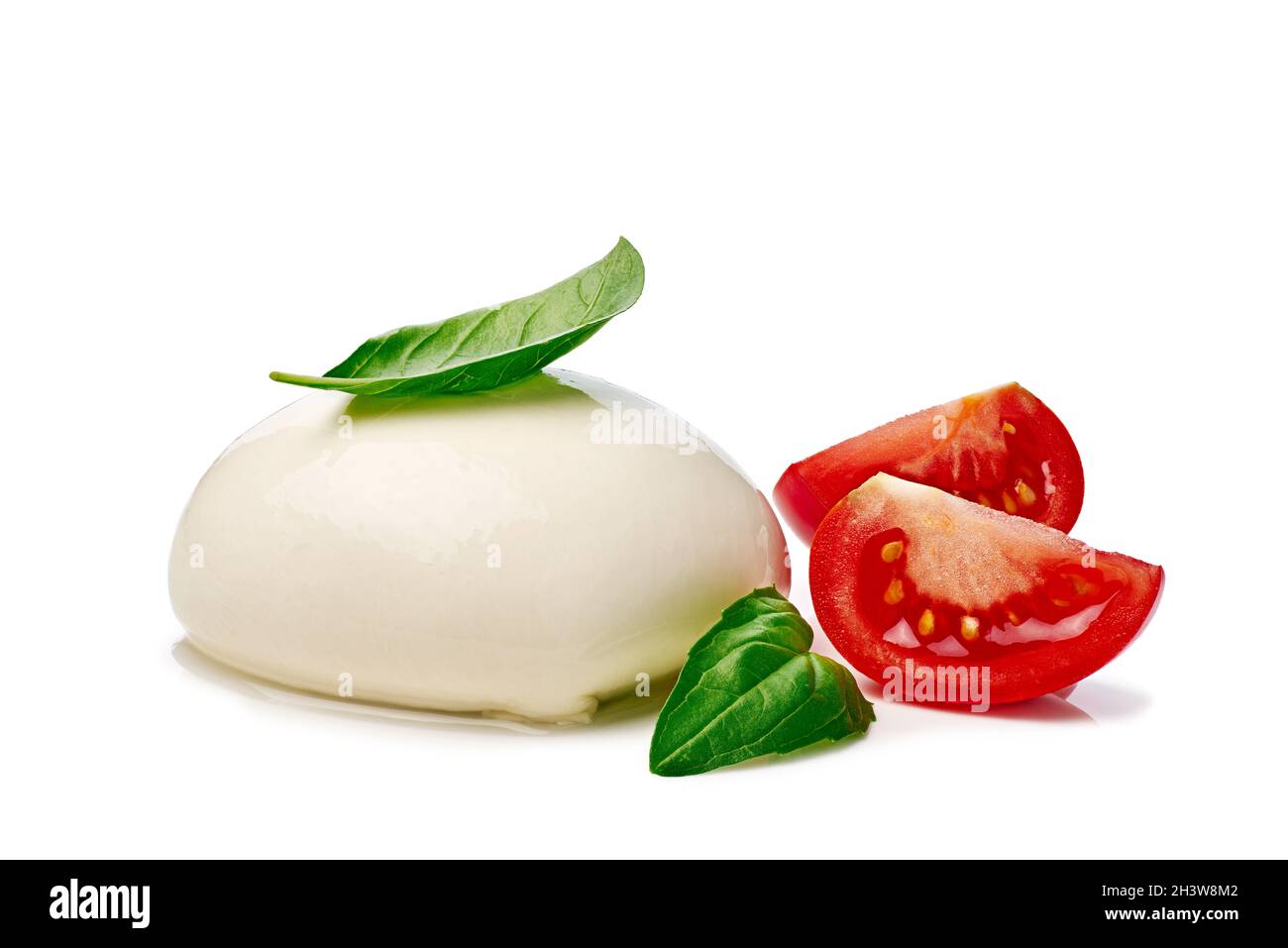 Mozzarella with tomato slices and basil on white background Stock Photo