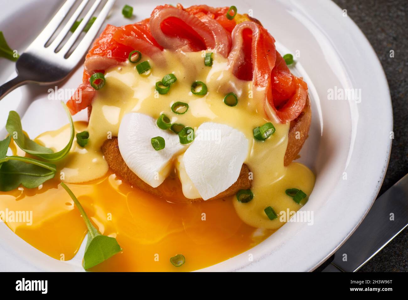 Eggs Benedict with salmon and hollandaise sauce on plate Stock Photo