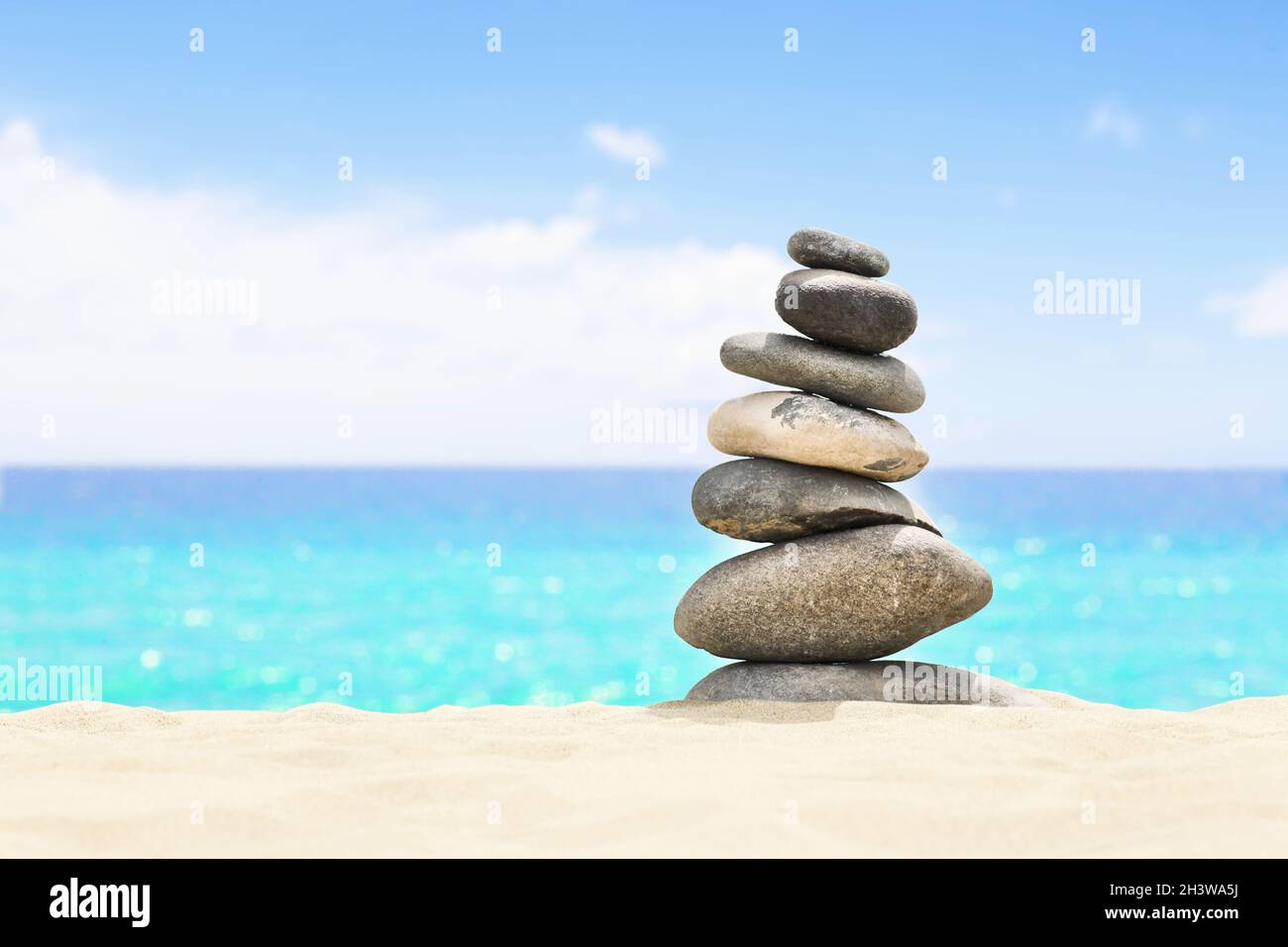 Balanced stones on a pebble beach during sunset Stock Photo - Alamy