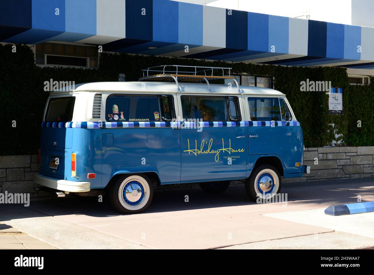 1960s blue painted VW Camper van with white-wall tyres and Holiday House graphics in Palm Springs CA Stock Photo