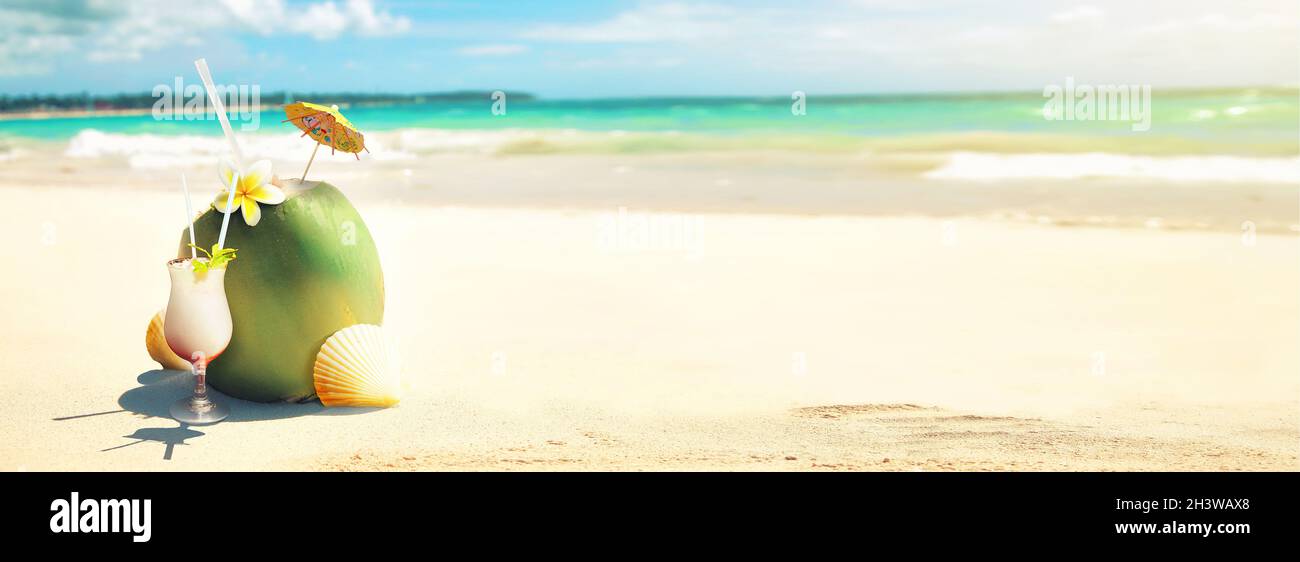 Summer coconut cocktail on the beach. Sunny day in topical island. Stock Photo