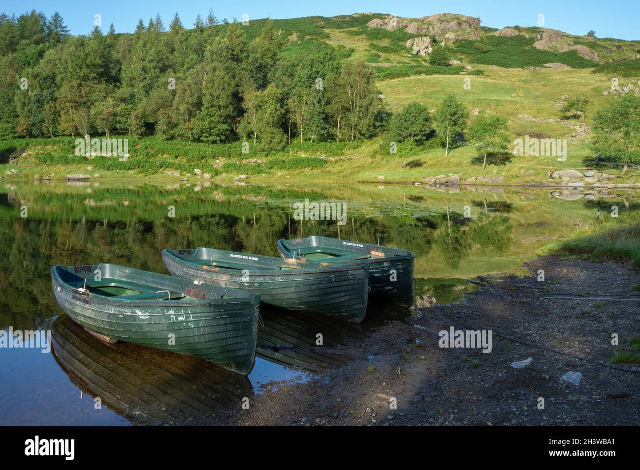 Rowing Boats Moored at Watendlath Tarn in the Lake District Cumbria Stock Photo