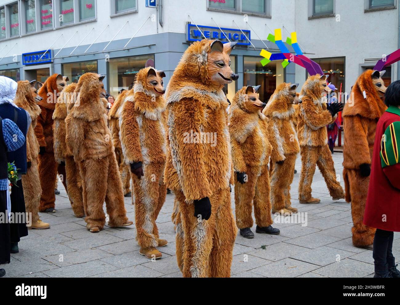 people dressed up in funny clothes and masks celebrating traditional German Shrovetide carnival called Fasching or Narrensprung in Ulm, Germany Stock Photo